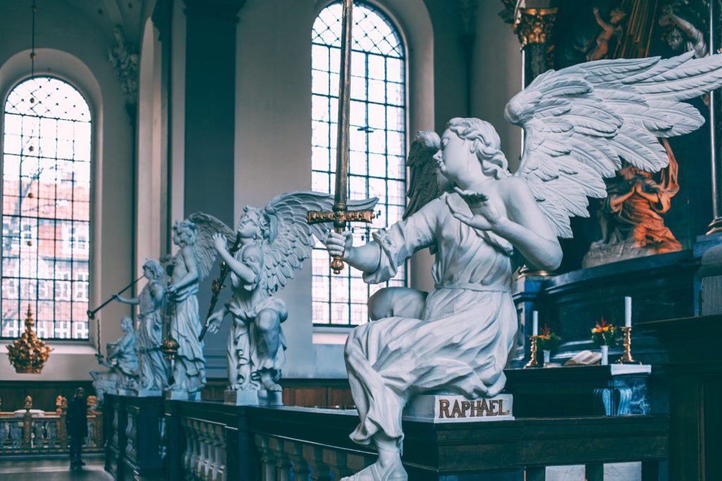 baroque altarpiece with sculptures of angels in catholic cathedral